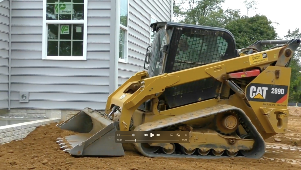 skid steer at Accudirt yard grading construction site
